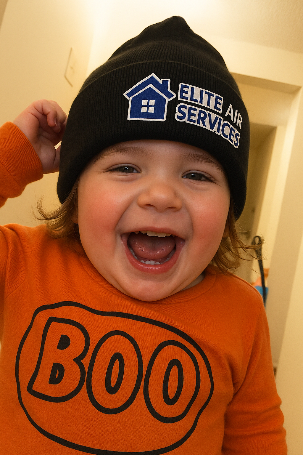 Happy child wearing Elite Air Services beanie